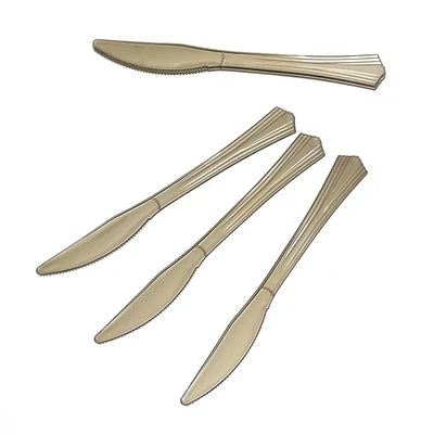 A set of gold polka dot disposable party tableware, including a dinner knife and a steak knife.