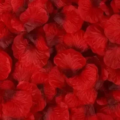 A close-up view of vibrant red simulation silk rose petals used for event decor.