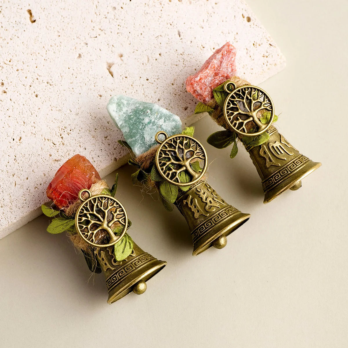 Natural crystal stones set in brass bells with copper finish and green foliage