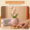 A pink tulip LED night light with a smooth finish sits on a wooden surface, demonstrating easy touch control.