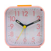 A pink digital alarm clock with an orange top showing the time and features a night light function.