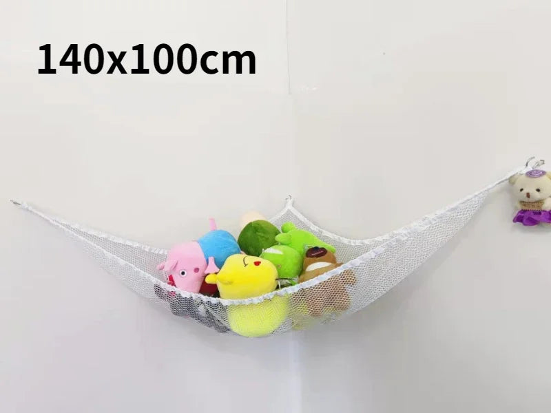 A white mesh storage hammock organizer for stuffed animals, displaying various colorful toys hanging on a wall.