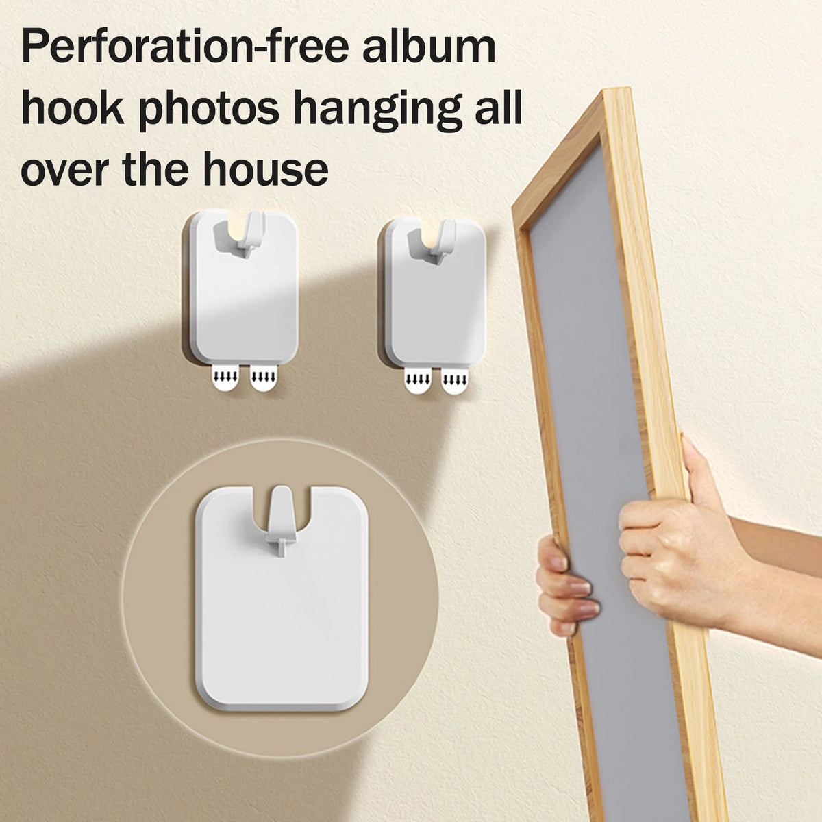 Two white perforation-free album hook photos hanging on a wall next to a wooden frame.