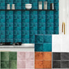 A kitchen backsplash featuring a teal tile wall and a countertop with various colored marble tiles.