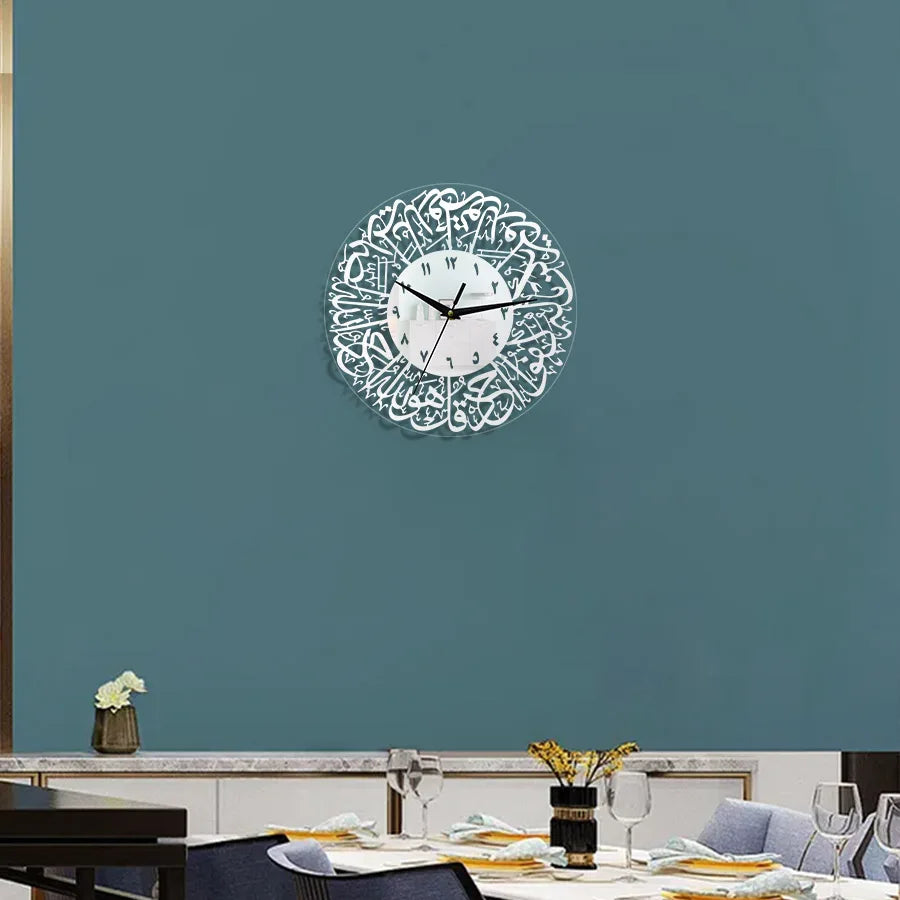 A white acrylic wall clock with intricate Arabic calligraphy design mounted on a teal wall.