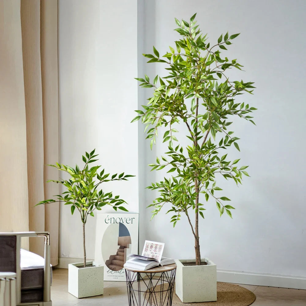 A tall artificial Nandina plant with bright green leaves displayed in a white pot against a light wall.