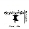 Black silhouette of a cat with musical notes and a treble clef design on metal wall decor