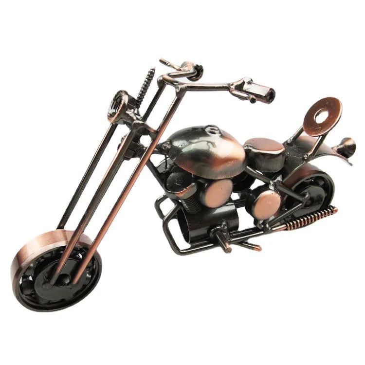 A vintage iron motorcycle figurine with a dark metal finish and detailed engine components.
