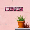 A pink wall sign with black leopard print featuring the text NAIL TECH AVE