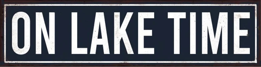 A dark metal sign with white text that reads ON LAKE TIME.