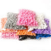 A collection of artificial foam rose flowers in various shades including pink, gray, white, orange, purple, and blue.