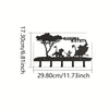 Decorative metal key hooks for wall organization featuring a silhouette of a tree and figures.