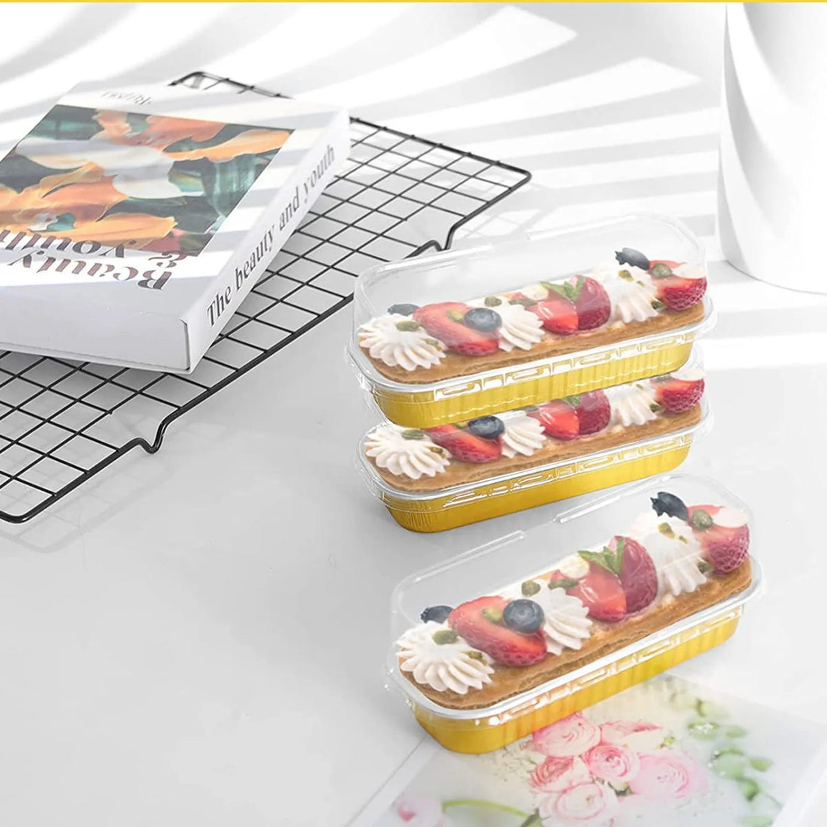 Disposable aluminum foil baking trays with lids filled with strawberry and cream fruit