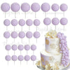 A set of purple foam cake toppers, including round and petal shapes, for decoration.
