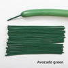 A green latex strip balloon and a bundle of green balloons for party decoration