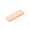 A rectangular building brick with a smooth texture in a light peach or salmon color.