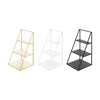 Three versions of a tiered display rack for cosmetics and jewelry in gold, white, and black.
