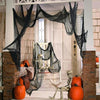 Black gauze fabric draped over a doorway frame for Halloween spooky decorations