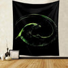 A black tapestry wall hanging featuring a glowing green alien predator silhouette in a circular motion.