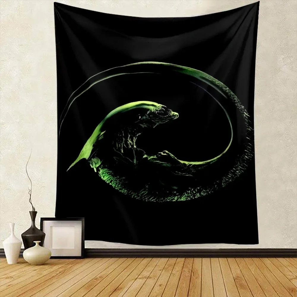 A black tapestry wall hanging featuring a glowing green alien predator silhouette in a circular motion.