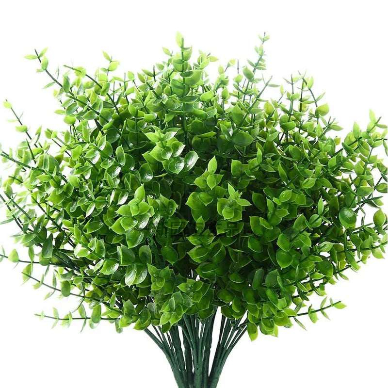 Une plante d'eucalyptus artificielle vert vif aux feuilles denses et arrondies.