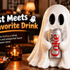 A white ghost figurine holding an aluminum soda can on a wooden table for Halloween decor.