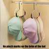 A display of various colored hats hanging on a metal rack.