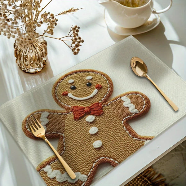 A set of four Christmas gingerbread man printed placemats on a light table setting.