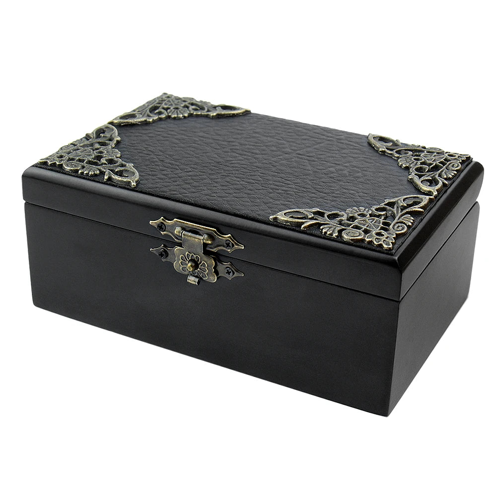 A black hand-cranked wooden music box with ornate gold detailing on the lid.