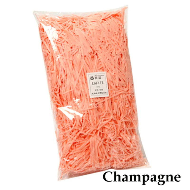 Bag of vibrant orange crinkle paper shreds used for gift boxes and party decor