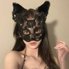 A woman wearing an elegant black lace half-face mask with cat ears and a floral design.