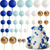 A collection of gold and silver foam ball cake toppers on sticks for party decorations