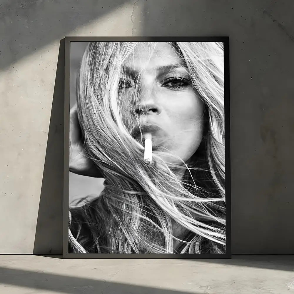 A black and white portrait of a woman with long blonde hair holding a cigarette, displayed in a framed poster.