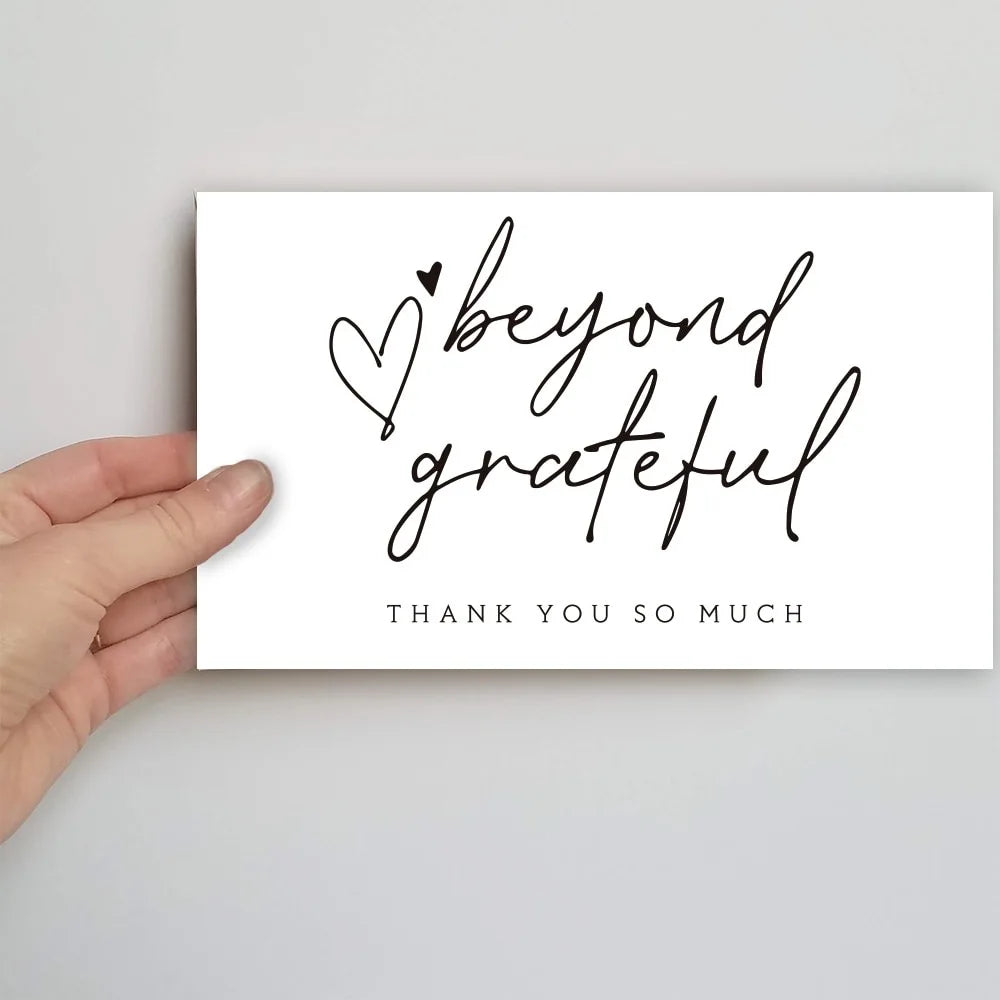 A white card with handwritten script saying beyond grateful and thank you so much