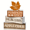 A tiered set of rustic wooden trays featuring maple leaf designs and labels for pumpkin spice, falling leaves, and apple cide