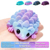 A hand holds a purple and blue 3D printed hedgehog figurine with various colored options displayed above.