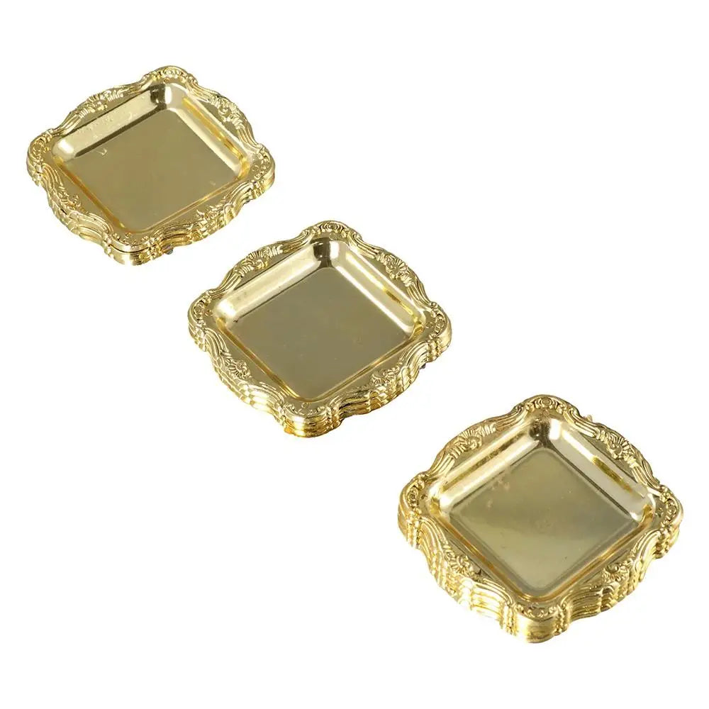 A set of three gold-colored mirror-finish mini trays for jewelry, snacks, and decor.