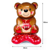 A large brown teddy bear balloon with a red heart design and a red foil finish.