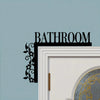 Black floral metal plaque with the word BATHROOM mounted on a light blue wall.