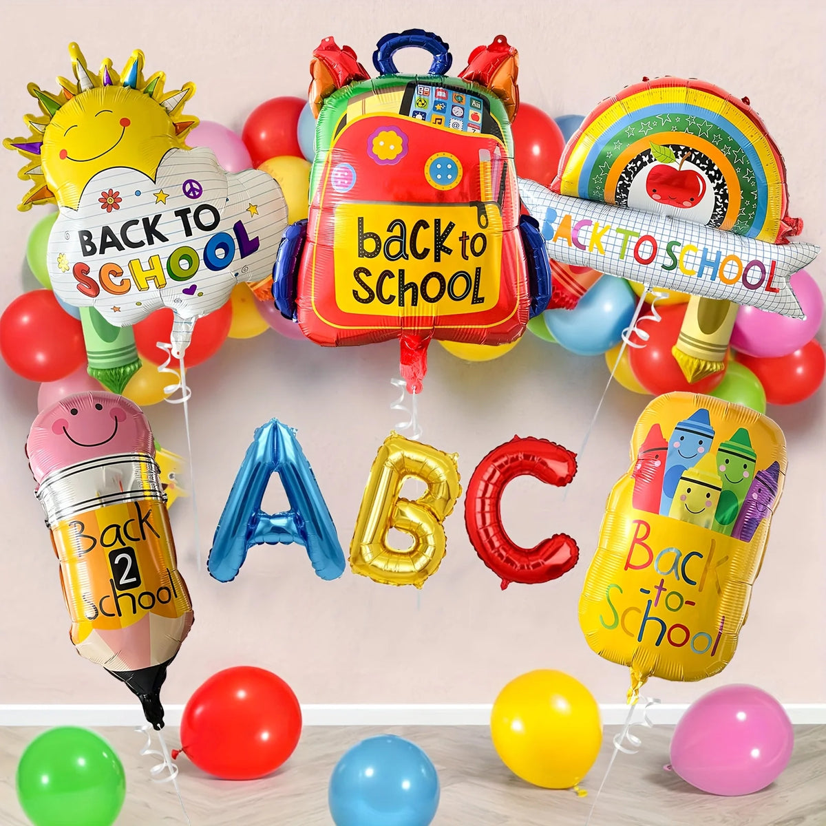 A colorful back to school decoration set featuring a backpack, sun, rainbow, and alphabet letters made of aluminum foil and b
