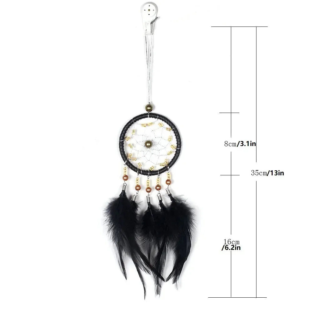 A dream catcher car pendant featuring a crystal mirror, beads, and black feathers.