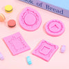 Four pink silicone frame molds for chocolate clay and crafts displayed on a light pink background.