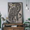 A framed canvas print featuring a black and white striped tiger cat design on a gray wall.