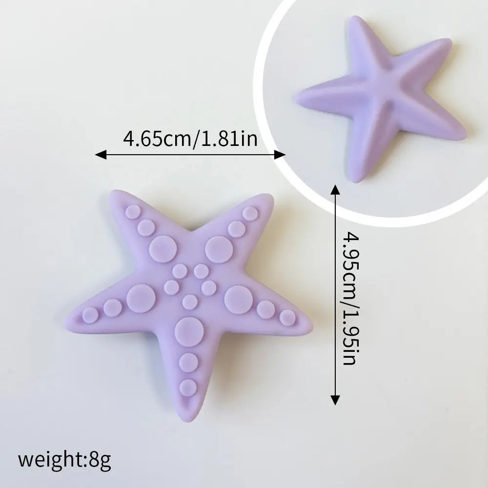 A purple starfish shaped cake topper with a textured surface is shown next to a measurement guide.