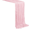 A rustic pink semi-sheer gauze table runner draped diagonally.