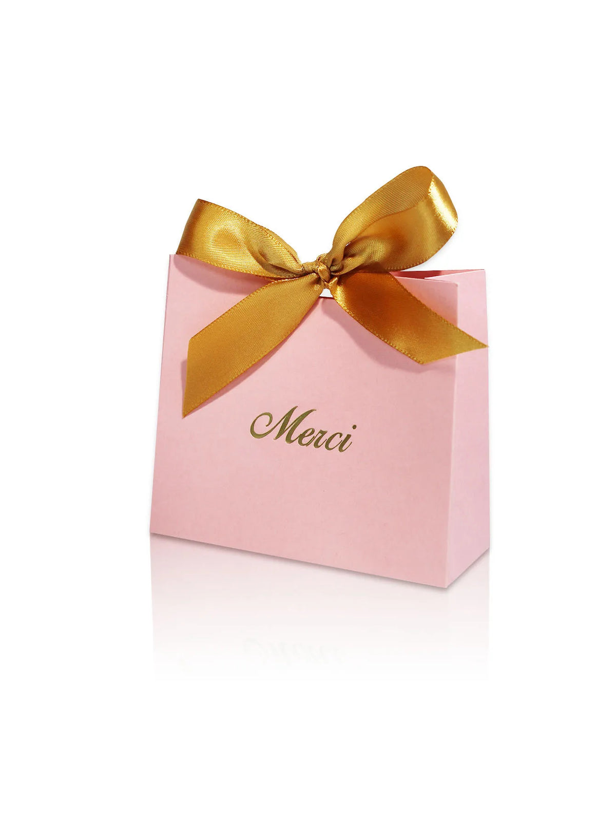 Pink paperboard gift box tied with a gold ribbon and the word Merci written on it.