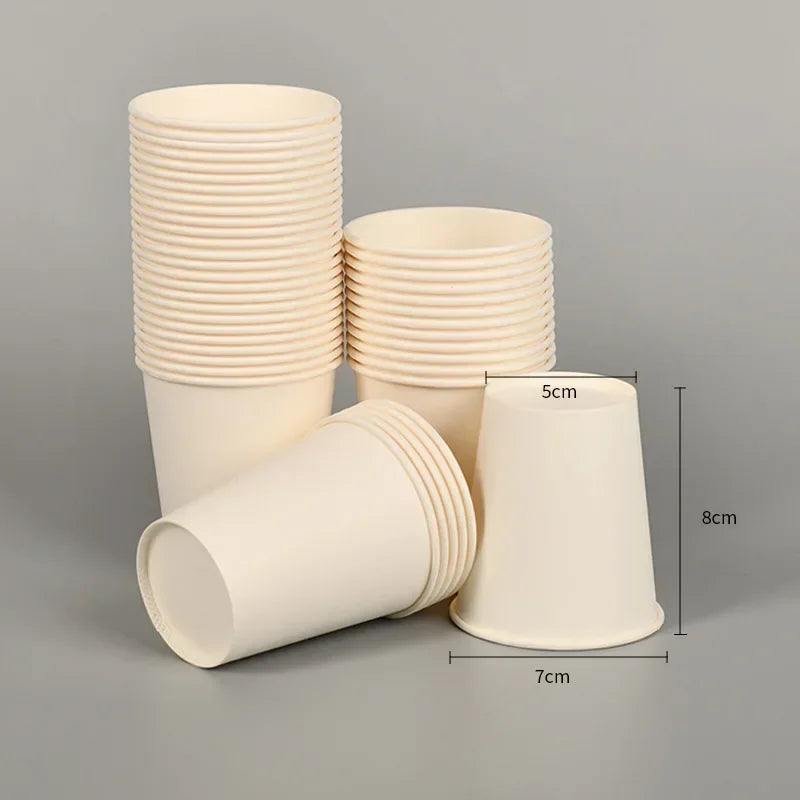 A stack of beige disposable paper cups, including a single cup, are shown against a gray background.