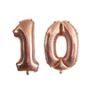 Two metallic rose gold foil number balloons shaped like 1 and 0