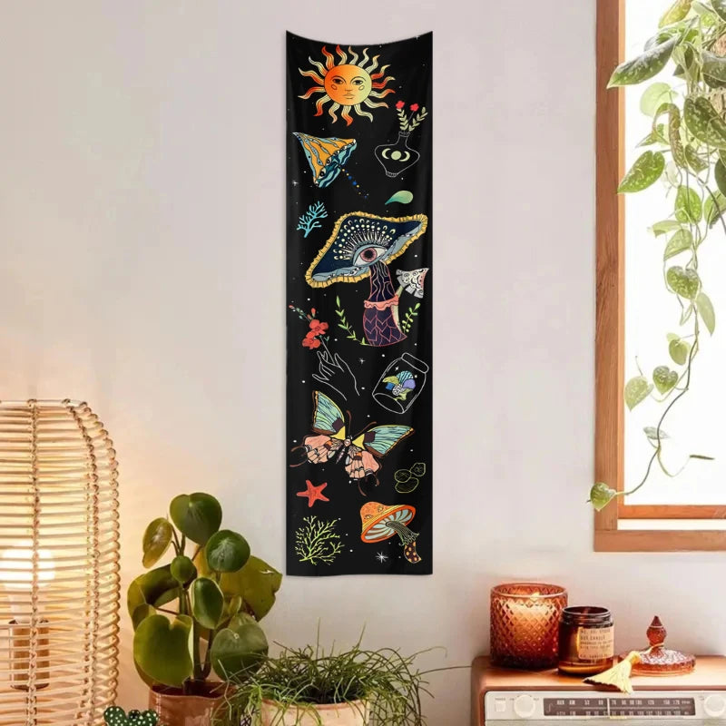A vertical tapestry featuring a dark background with celestial elements like a sun, moon, and galaxy, along with various mush