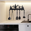 A black metal key holder with mountain forest silhouette hooks is displayed above a kitchen countertop.